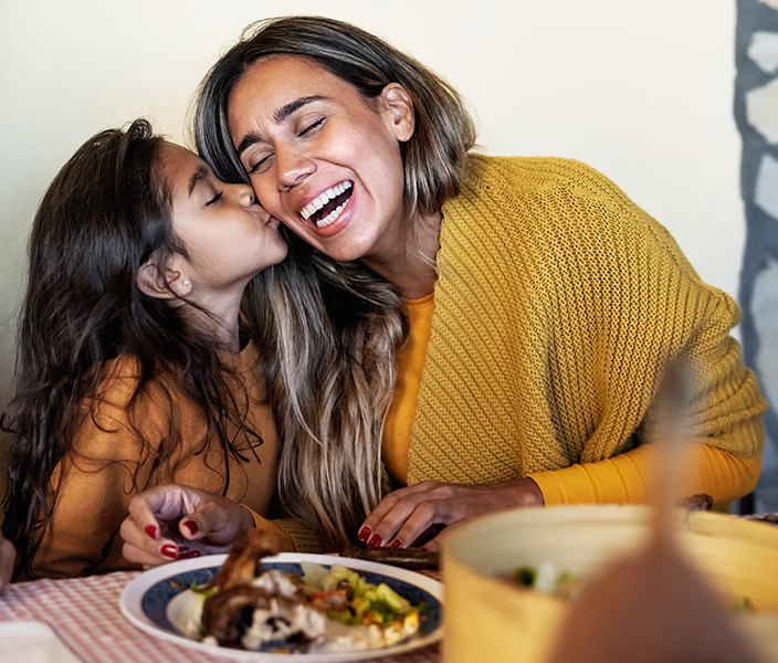 A mother and daughter dining together at a restaurant