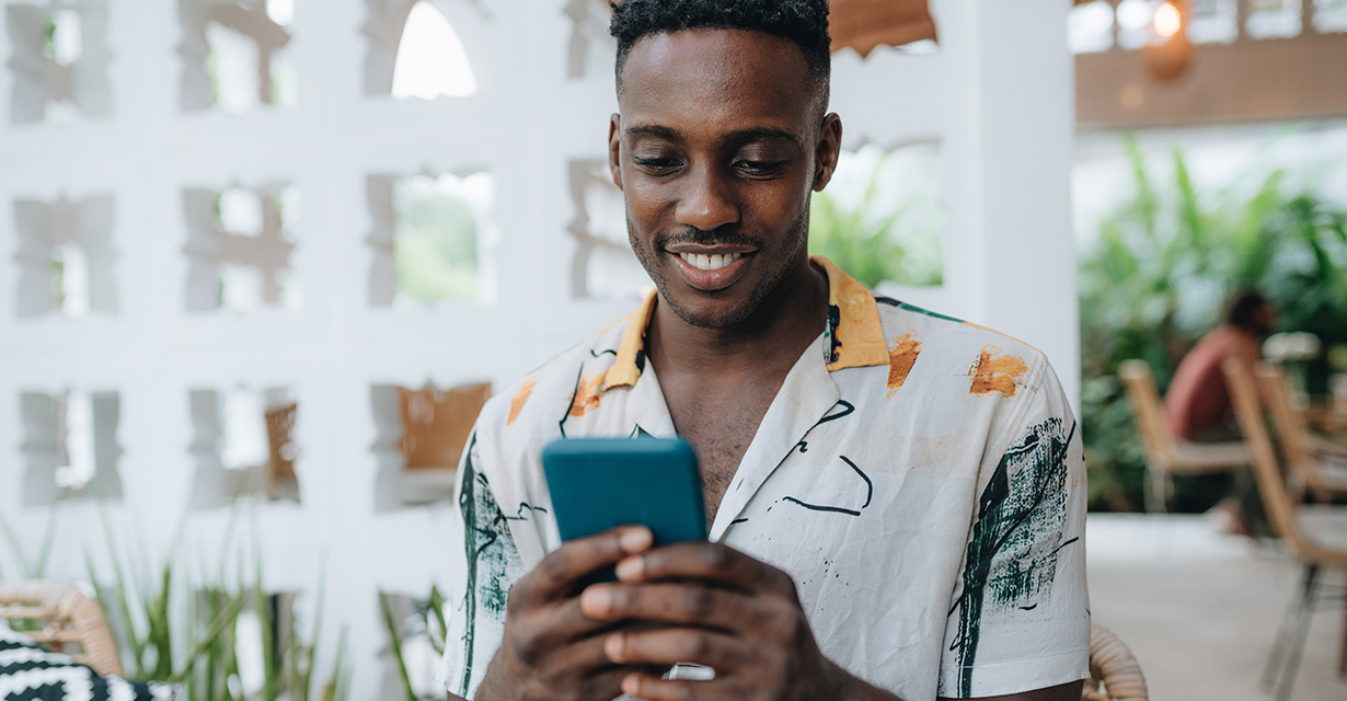 A man on vacation at a resort texting